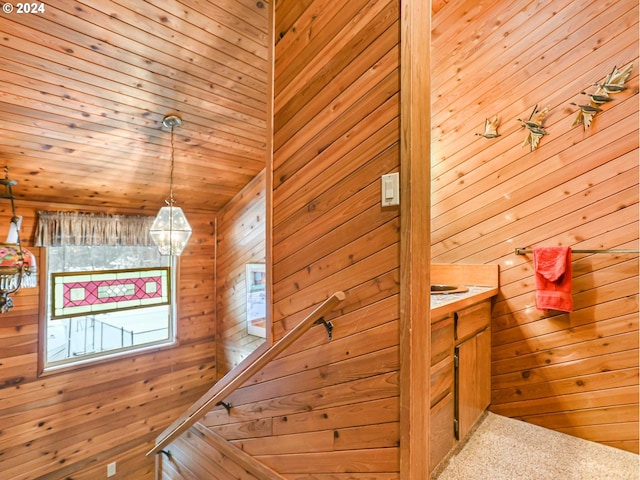 24940 E Tillicum St, Welches, OR 97067 - stairs with wooden walls, a chandelier, and carpet floors