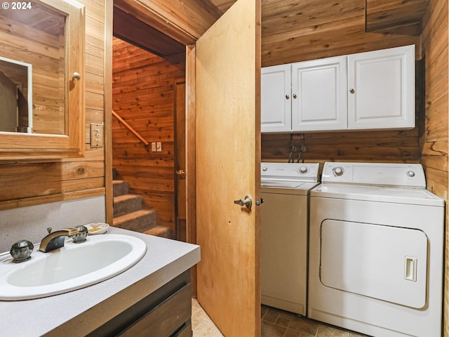 24940 E Tillicum St, Welches, OR 97067 - washroom featuring washer and dryer, wooden walls, and cabinet space