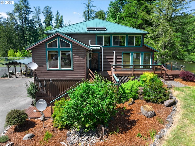 24940 E Tillicum St, Welches, OR 97067 - rustic home featuring a deck, faux log siding, and metal roof