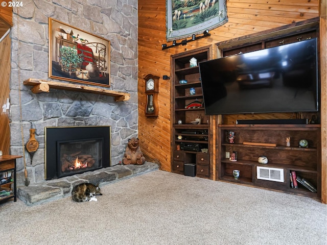 24940 E Tillicum St, Welches, OR 97067 - carpeted living room with wooden walls and a stone fireplace