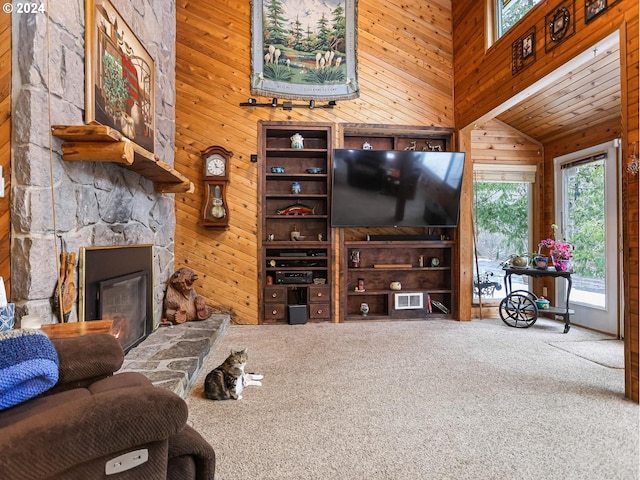 24940 E Tillicum St, Welches, OR 97067 - carpeted living room with wood walls, vaulted ceiling, and a fireplace
