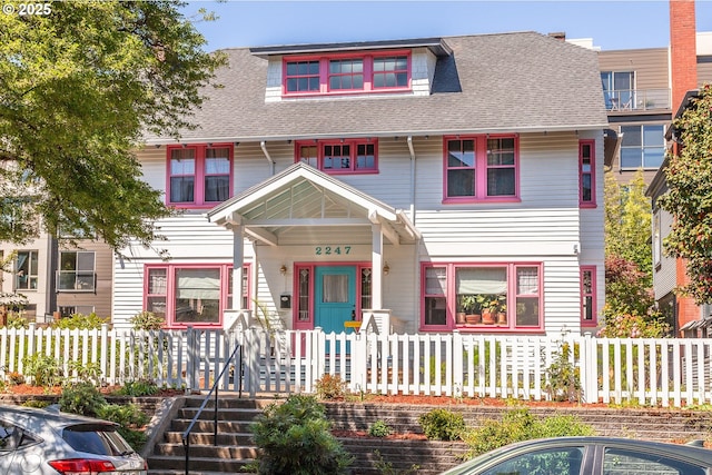 view of front facade with roof with shingles and covered porch