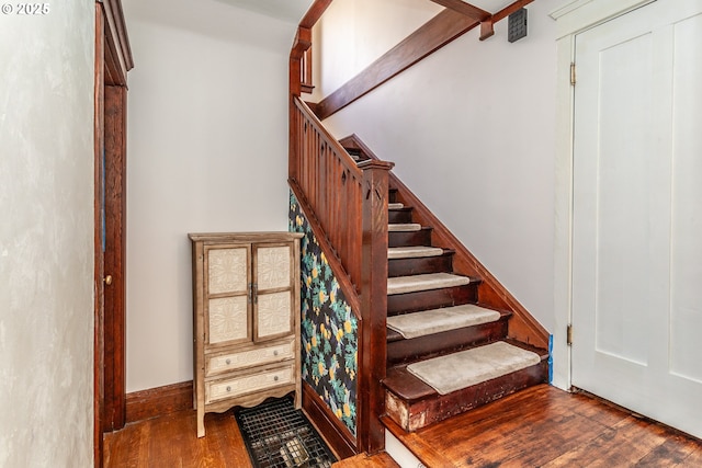 staircase with wood finished floors