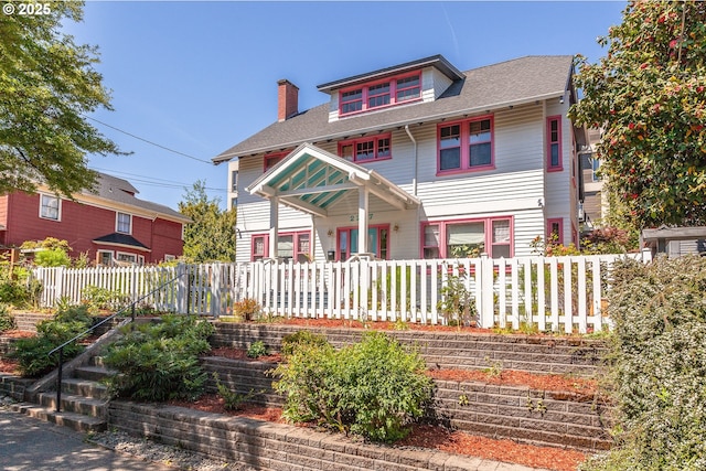 view of front of property featuring fence and a chimney
