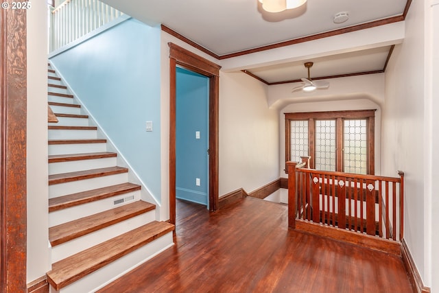 stairs featuring wood finished floors, ceiling fan, baseboards, and ornamental molding