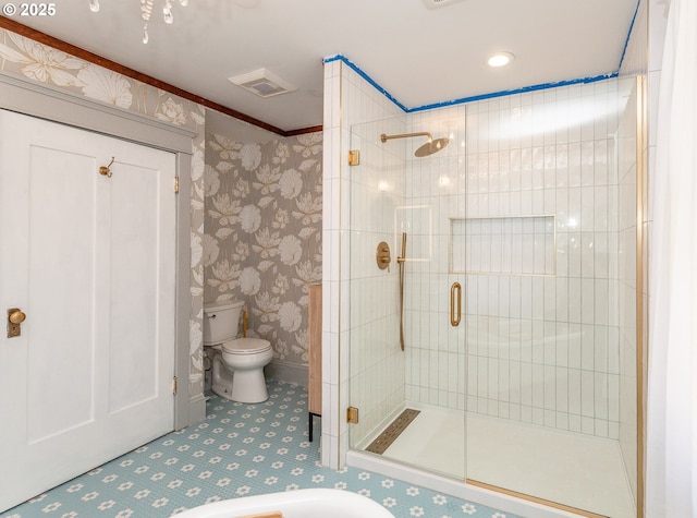 bathroom featuring toilet, a stall shower, ornamental molding, and wallpapered walls