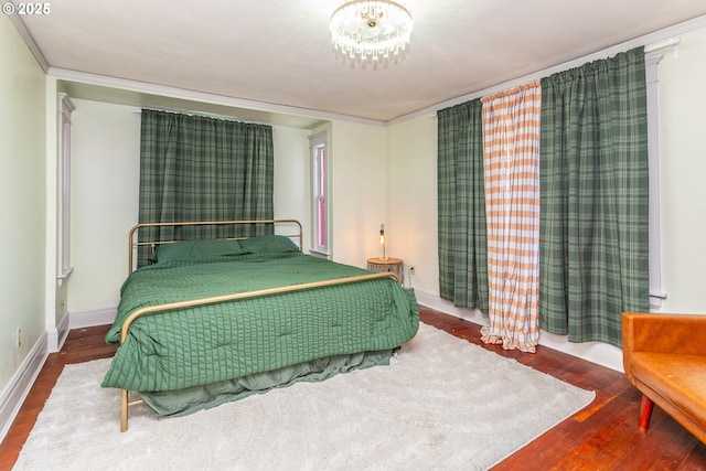 bedroom featuring wood finished floors and baseboards