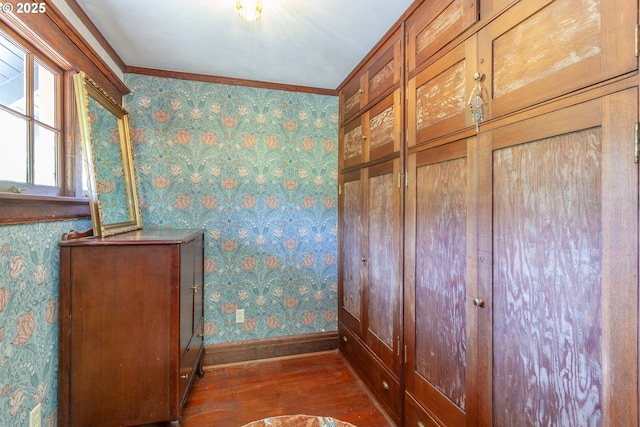 detailed view of wallpapered walls, baseboards, wood finished floors, and ornamental molding