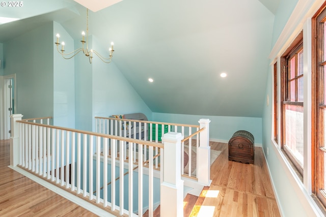 bonus room with vaulted ceiling, wood finished floors, a chandelier, baseboards, and recessed lighting