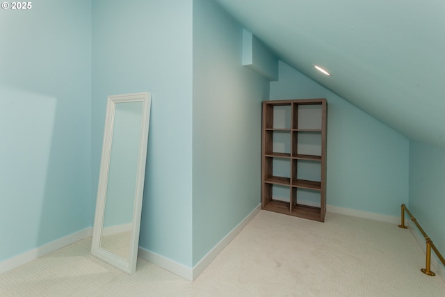 additional living space featuring lofted ceiling, carpet floors, and baseboards