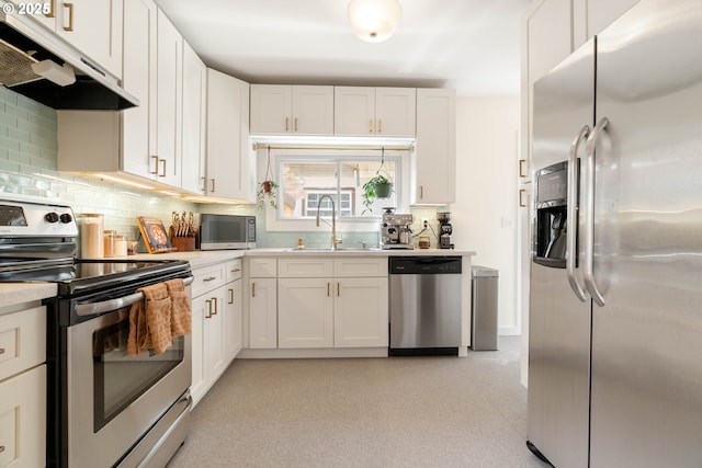 6232 NE 6th Ave, Portland, OR 97211 - kitchen featuring stainless steel appliances, under cabinet range hood, a sink, light countertops, and backsplash