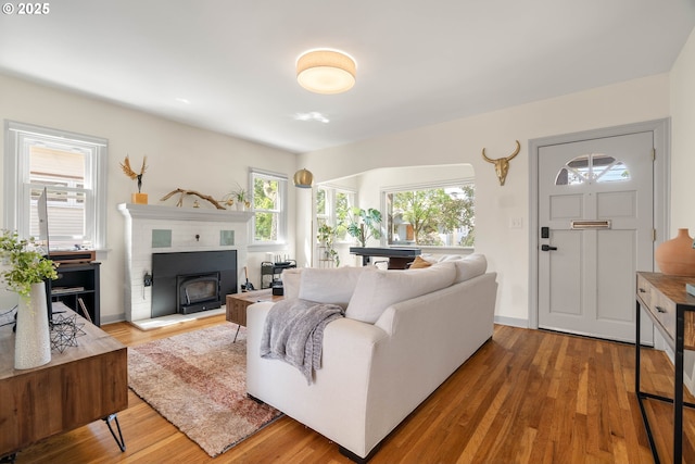 6232 NE 6th Ave, Portland, OR 97211 - living room featuring wood finished floors, a fireplace with raised hearth, and baseboards