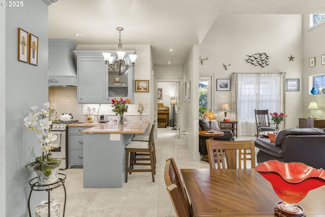 dining room featuring a chandelier, healthy amount of natural light, light tile patterned flooring, and recessed lighting