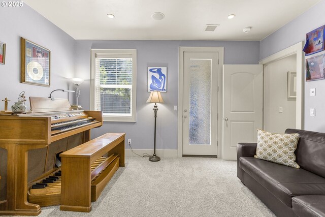living area with carpet, baseboards, and recessed lighting