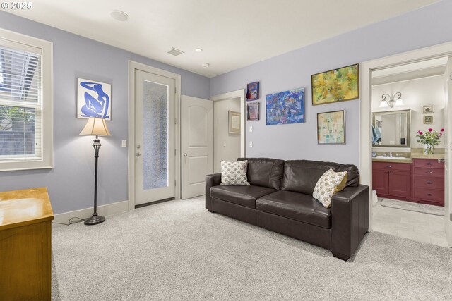living area featuring light carpet