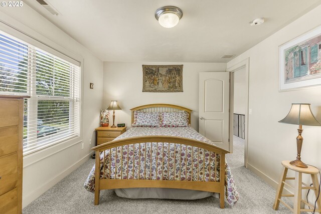 hallway with an upstairs landing, carpet flooring, and recessed lighting