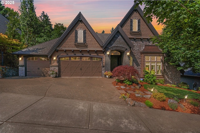 9641 SE Nicholas Dr, Happy Valley, OR 97086 - view of front of property featuring stone siding, a garage, and concrete driveway