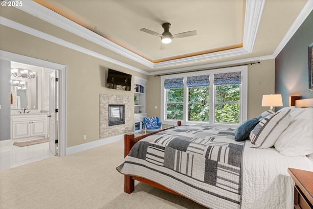 9641 SE Nicholas Dr, Happy Valley, OR 97086 - carpeted bedroom with a tray ceiling, ornamental molding, a glass covered fireplace, ensuite bathroom, and a chandelier