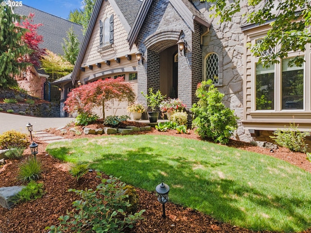 9641 SE Nicholas Dr, Happy Valley, OR 97086 - view of front facade with a front lawn, stone siding, brick siding, and concrete driveway