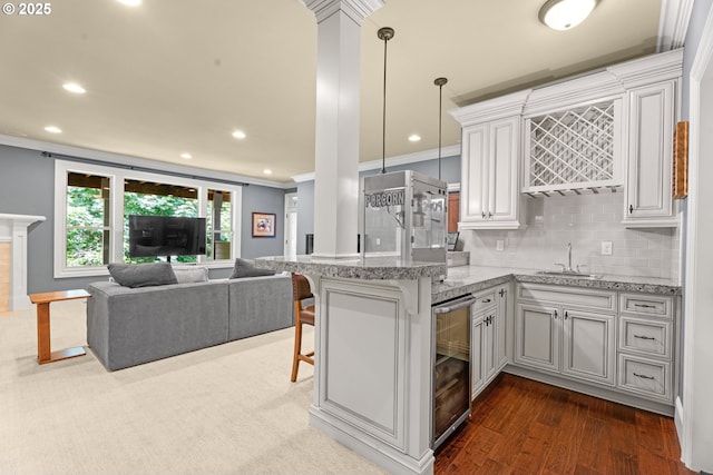 9641 SE Nicholas Dr, Happy Valley, OR 97086 - kitchen with wine cooler, crown molding, open floor plan, recessed lighting, and backsplash