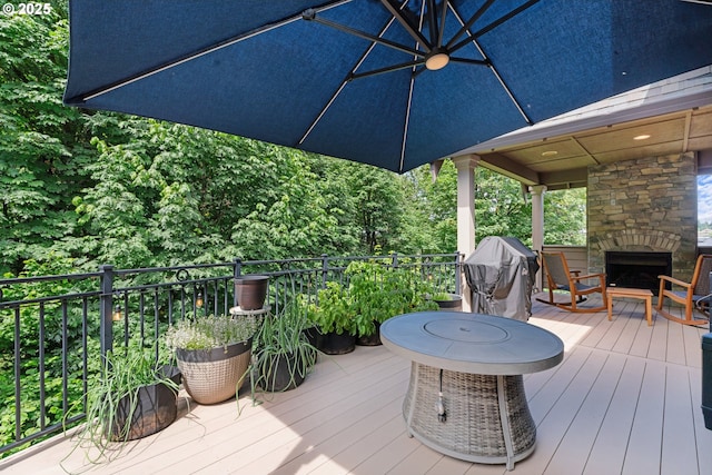 9641 SE Nicholas Dr, Happy Valley, OR 97086 - wooden deck with an outdoor stone fireplace and area for grilling