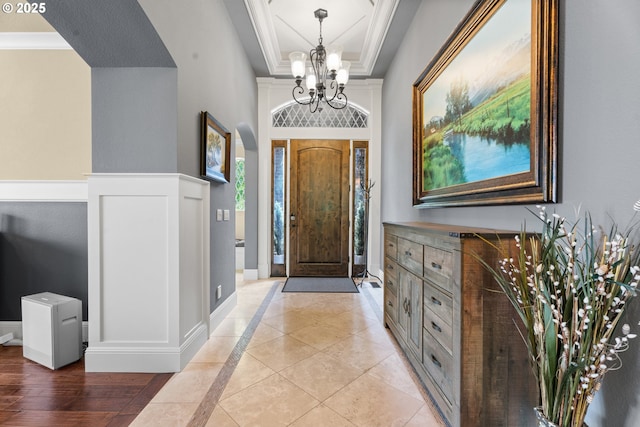 9641 SE Nicholas Dr, Happy Valley, OR 97086 - foyer featuring a chandelier, a raised ceiling, ornamental molding, and inlaid floor details