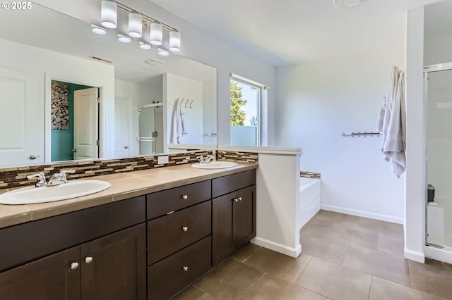 51276 SW Rembrandt Dr, Scappoose, OR 97056 - full bath featuring a stall shower, double vanity, a garden tub, tile patterned flooring, and tasteful backsplash