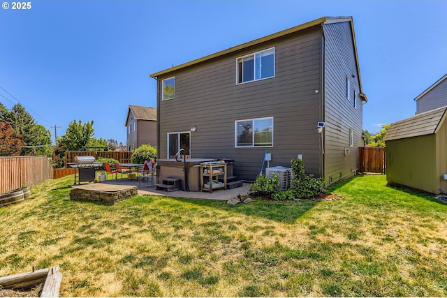 51276 SW Rembrandt Dr, Scappoose, OR 97056 - rear view of house with a patio, a fenced backyard, a hot tub, and a storage unit