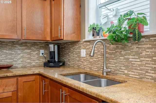12146 SW Palermo St, Wilsonville, OR 97070 - kitchen with backsplash, brown cabinets, and light stone countertops