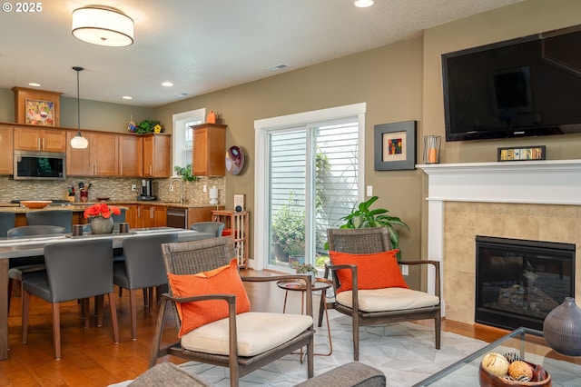 12146 SW Palermo St, Wilsonville, OR 97070 - kitchen featuring stainless steel appliances, light wood finished floors, brown cabinetry, backsplash, and recessed lighting