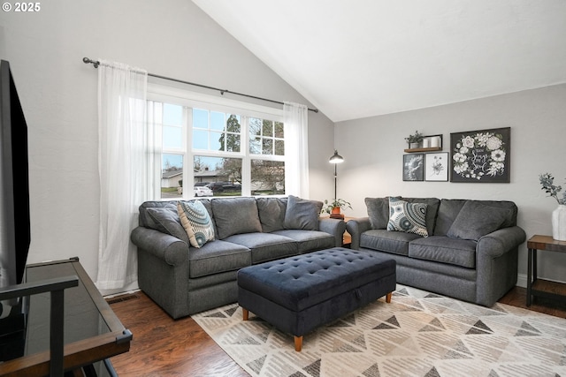 living room featuring lofted ceiling and hardwood / wood-style floors