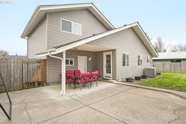 rear view of property featuring central air condition unit and a patio