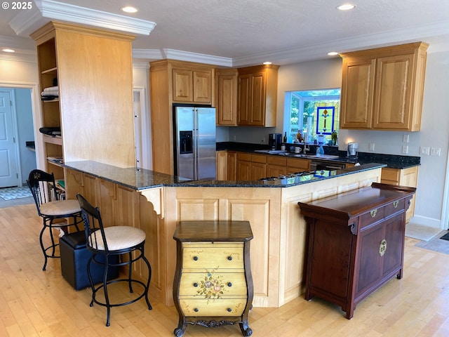 97661 Marina Heights Loop, Brookings, OR 97415 - kitchen featuring stainless steel appliances, light wood finished floors, ornamental molding, a breakfast bar area, and open shelves