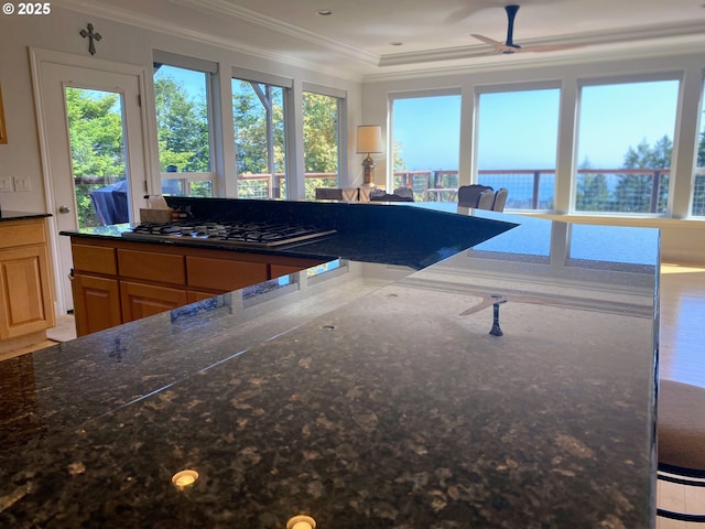 97661 Marina Heights Loop, Brookings, OR 97415 - kitchen featuring ornamental molding, stainless steel gas cooktop, ceiling fan, and dark stone counters