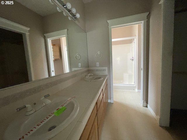 15732 NE Russell St, Portland, OR 97230 - bathroom featuring double vanity and baseboards
