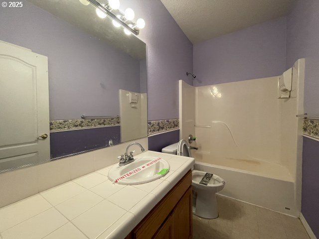 15732 NE Russell St, Portland, OR 97230 - full bathroom featuring tile patterned flooring, shower / tub combination, toilet, and vanity