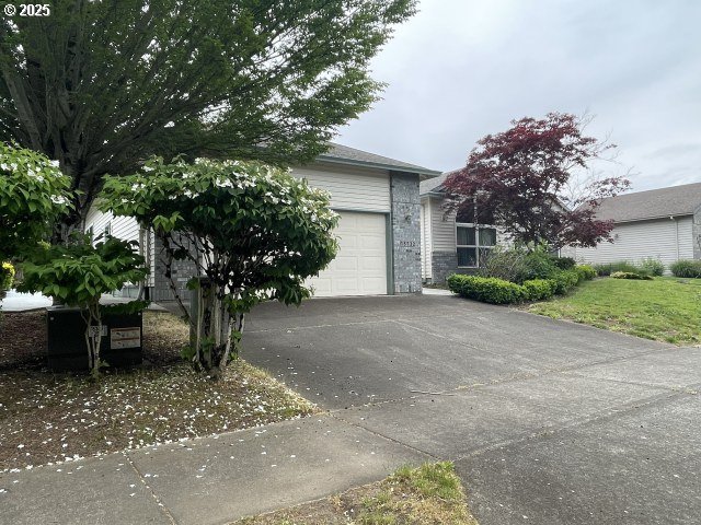 15732 NE Russell St, Portland, OR 97230 - view of front of property with concrete driveway, an attached garage, and brick siding