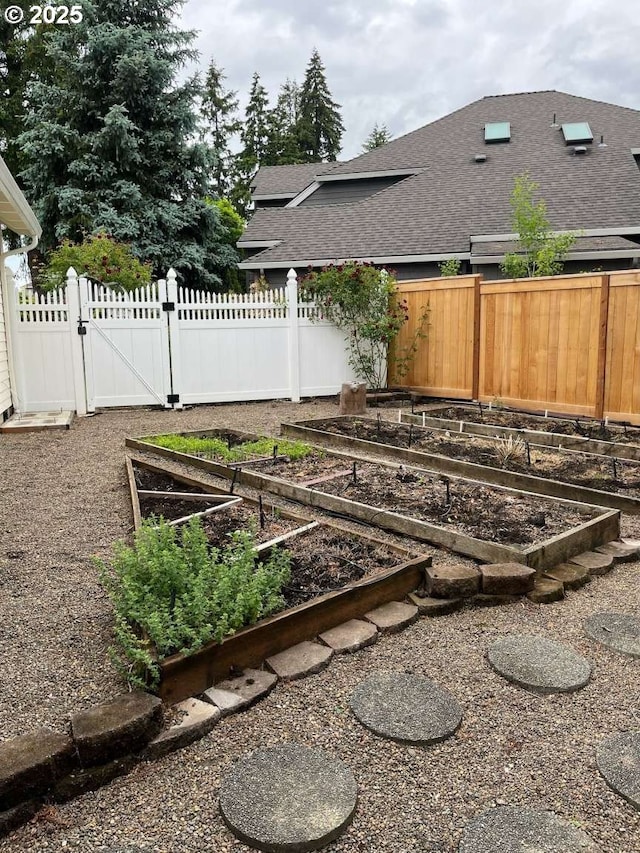 3553 NW 163rd Ct, Beaverton, OR 97006 - fenced yard featuring a garden and a gate