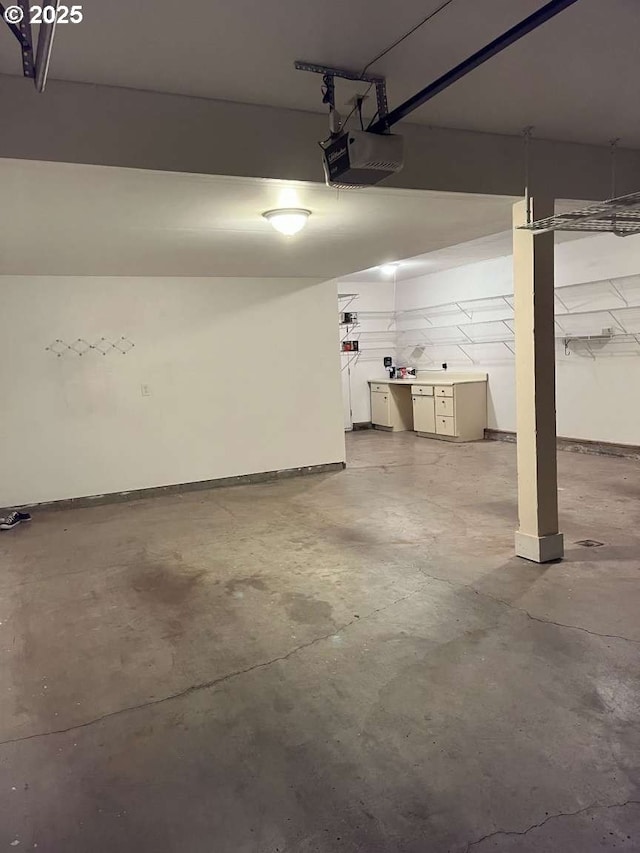 3553 NW 163rd Ct, Beaverton, OR 97006 - garage featuring a garage door opener and baseboards