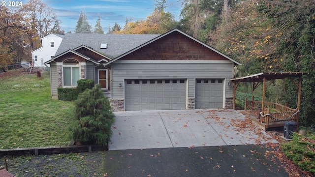 33015 School St, Rainier, OR 97048 - view of front of house featuring driveway, an attached garage, stone siding, a front yard, and roof with shingles