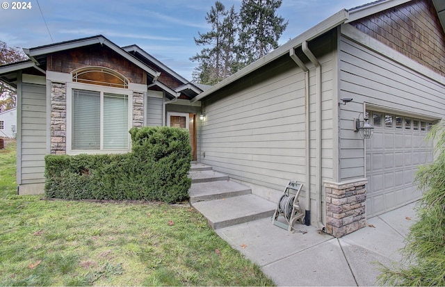 33015 School St, Rainier, OR 97048 - view of exterior entry featuring stone siding and a garage
