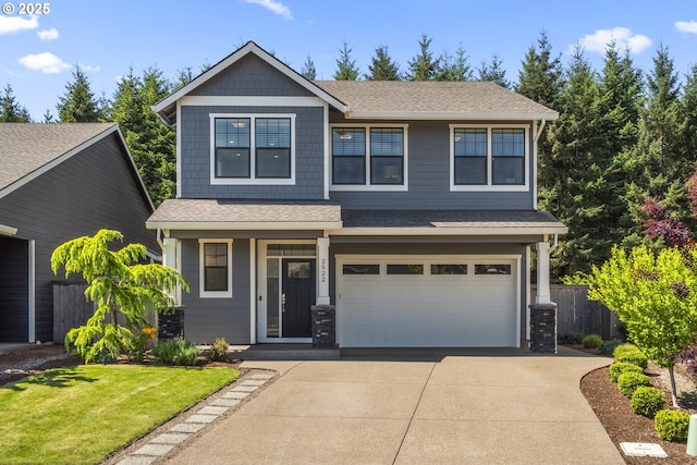 2522 S Lydia Loop, Hubbard, OR 97032 - view of front of house featuring driveway, an attached garage, roof with shingles, and a porch
