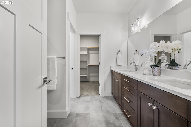 2522 S Lydia Loop, Hubbard, OR 97032 - bathroom featuring double vanity, a spacious closet, and baseboards