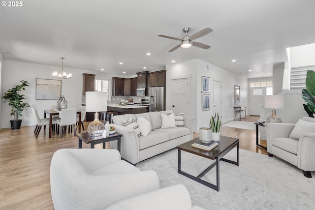 2522 S Lydia Loop, Hubbard, OR 97032 - living area featuring recessed lighting, a chandelier, ceiling fan, light wood-style flooring, and baseboards