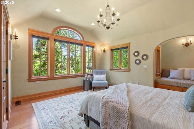 17367 Canal Cir, Lake Oswego, OR 97035 - bedroom featuring vaulted ceiling, arched walkways, a chandelier, wood finished floors, and baseboards