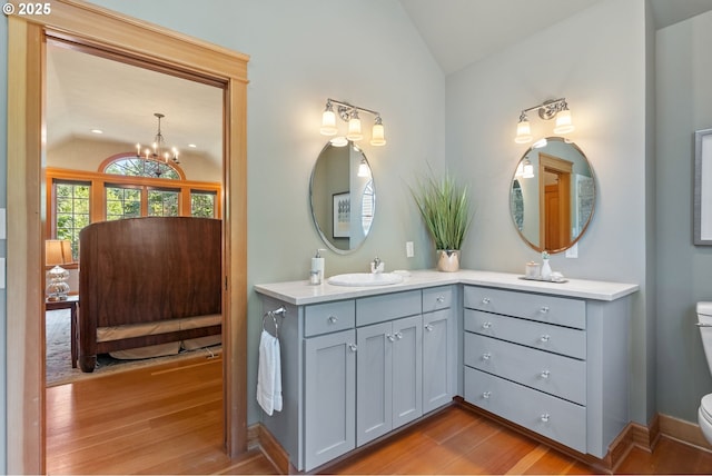 17367 Canal Cir, Lake Oswego, OR 97035 - bathroom featuring lofted ceiling, toilet, vanity, wood finished floors, and a chandelier