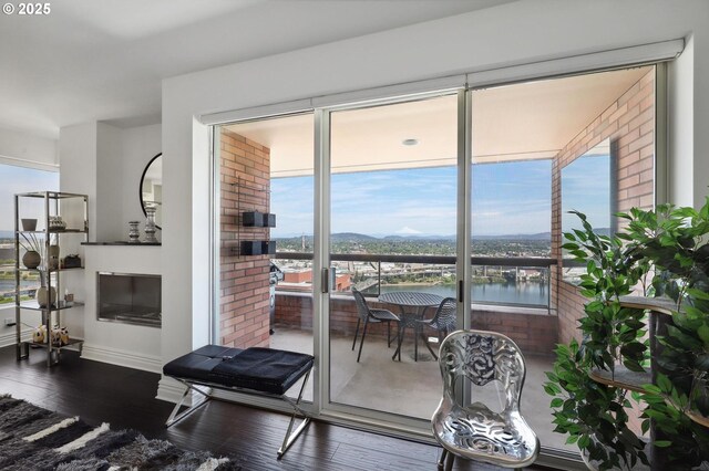 living area with hardwood / wood-style flooring, baseboards, and a water view