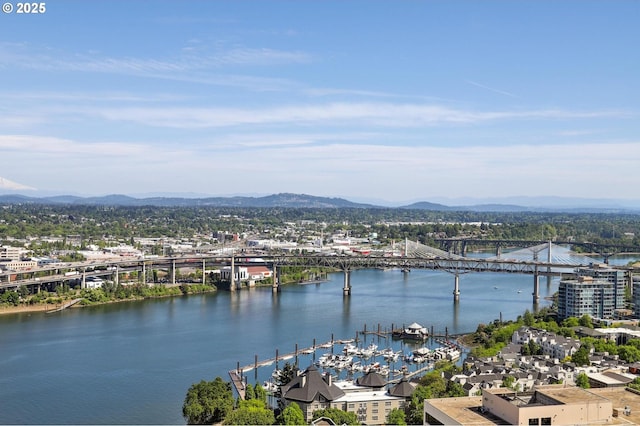 water view featuring a notable bridge and a mountainous background