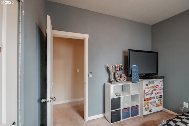 bedroom featuring baseboards and carpet