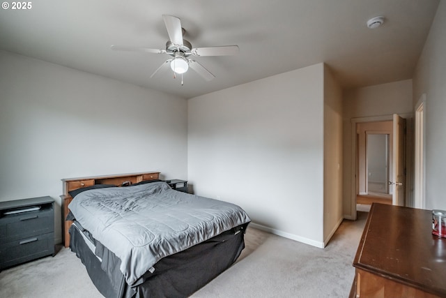 bedroom featuring baseboards, a ceiling fan, and light colored carpet